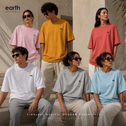 Six models wearing oversized Earth Apparel t-shirts in pink, mustard yellow, coral red, white, gray, and light blue, styled in a warm, sunlit architectural setting.