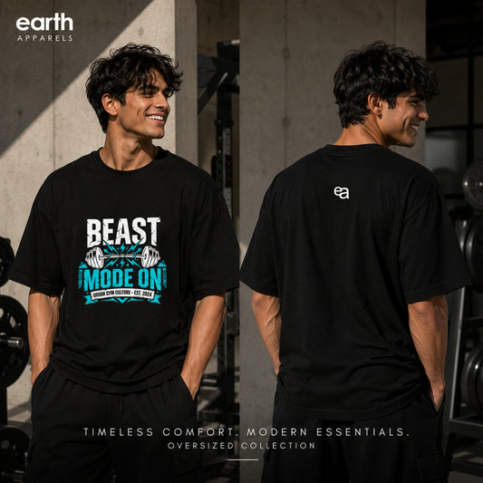 A man modeling a black graphic oversized T-shirt in a gym setting, shown from both the front and back. The front features a white and teal graphic that reads 'BEAST MODE ON'.