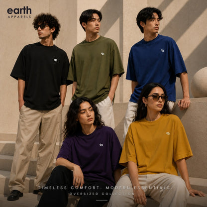 Five models wearing oversized Earth Apparel t-shirts in black, olive green, royal blue, purple, and mustard yellow, posed on outdoor stone steps under warm sunlight.